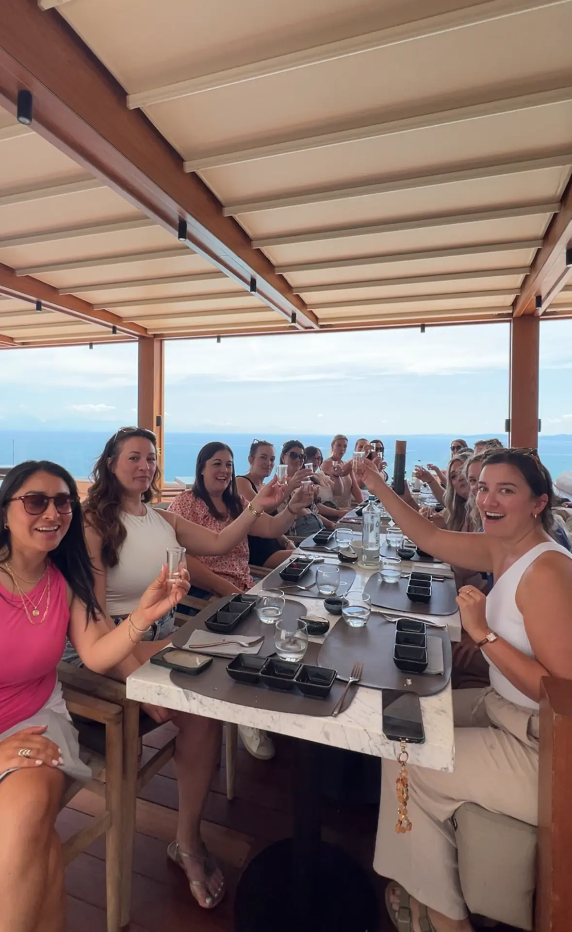 Women toasting at a long table on a SERA retreat